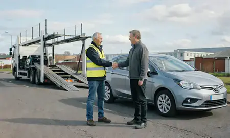 Vehicle owner beside their delivered car in Smethwick, West Midlands, United Kingdom