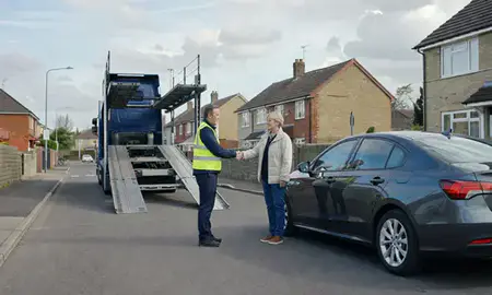 Vehicle owner beside their delivered car in Solihull, West Midlands, United Kingdom