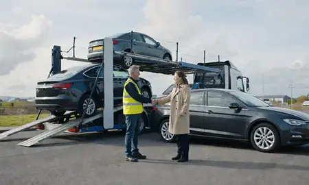 Vehicle owner beside their delivered car in Tipton, West Midlands, United Kingdom