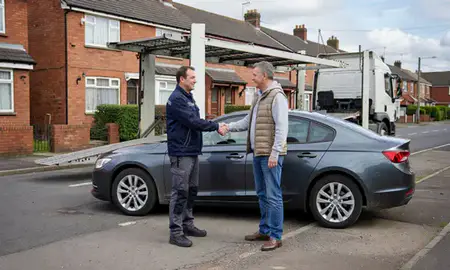 Vehicle owner beside their delivered car in Walsall, West Midlands, United Kingdom
