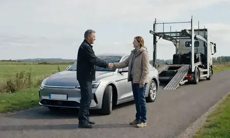 Vehicle owner beside their delivered car in West Sussex, United Kingdom