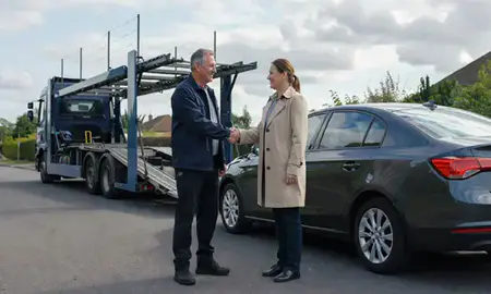 Vehicle owner beside their delivered car in Bognor Regis, West Sussex, United Kingdom