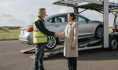 Vehicle owner beside their delivered car in Haywards Heath, West Sussex, United Kingdom