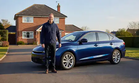Customer with their delivered car in Horsham, West Sussex, United Kingdom