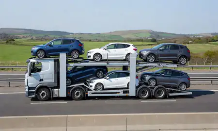 Multi-level car carrier on the motorway to Littlehampton, West Sussex, United Kingdom