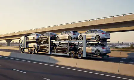 Car transporter with the Worthing, West Sussex, United Kingdom skyline behind it