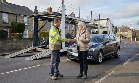 Vehicle owner beside their delivered car in West Yorkshire, United Kingdom
