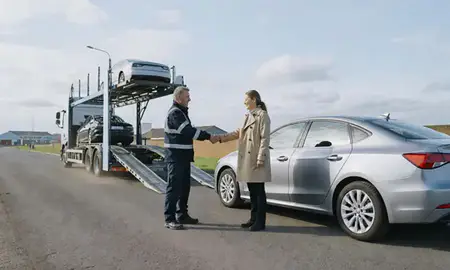 Vehicle owner beside their delivered car in Castleford, West Yorkshire, United Kingdom