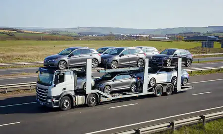 Multi-level car carrier on the motorway to Dewsbury, West Yorkshire, United Kingdom