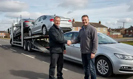 Vehicle owner beside their delivered car in Dewsbury, West Yorkshire, United Kingdom