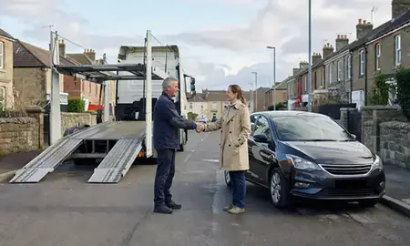 Vehicle owner beside their delivered car in Halifax, West Yorkshire, United Kingdom