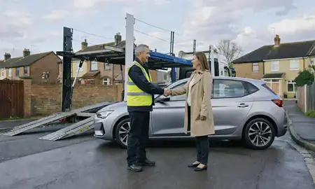 Vehicle owner beside their delivered car in Huddersfield, West Yorkshire, United Kingdom