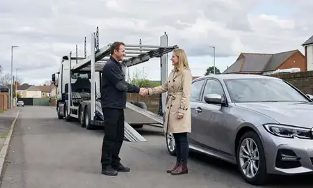 Vehicle owner beside their delivered car in Leeds, West Yorkshire, United Kingdom