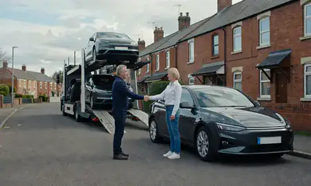 Vehicle owner beside their delivered car in Wakefield, West Yorkshire, United Kingdom