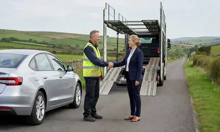 Vehicle owner beside their delivered car in Wiltshire, United Kingdom