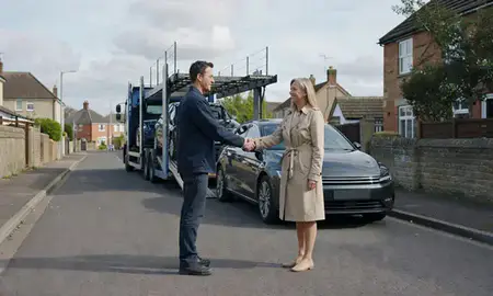 Vehicle owner beside their delivered car in Salisbury, Wiltshire, United Kingdom