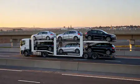 Car transporter with the Salisbury, Wiltshire, United Kingdom skyline behind it