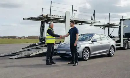 Vehicle owner beside their delivered car in Redditch, Worcestershire, United Kingdom