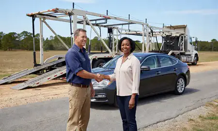 Vehicle owner beside their delivered car in Alabama, United States