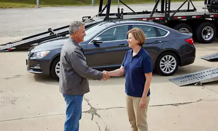 Vehicle owner beside their delivered car in Anniston, Alabama, United States