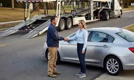 Vehicle owner beside their delivered car in Athens, Alabama, United States