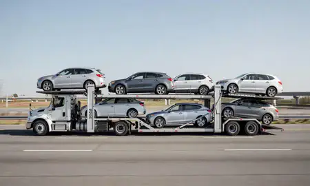 Multi-level car carrier on the highway to Auburn, Alabama, United States