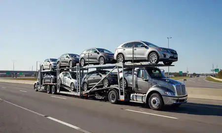 Multi-level car carrier on the highway to Birmingham, Alabama, United States