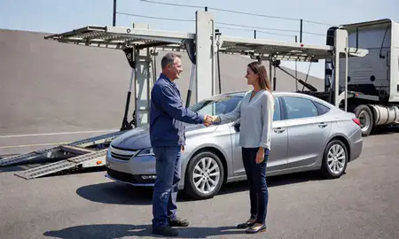 Vehicle owner beside their delivered car in Decatur, Alabama, United States