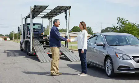 Vehicle owner beside their delivered car in Opelika, Alabama, United States