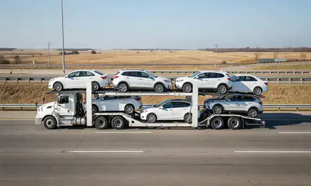 Multi-level car carrier on the highway to Phenix City, Alabama, United States