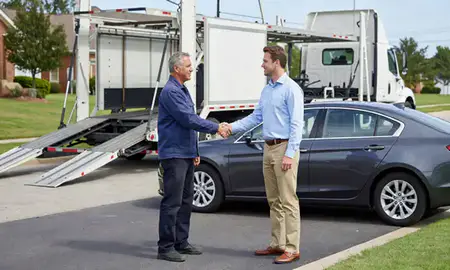 Vehicle owner beside their delivered car in Tuscaloosa, Alabama, United States