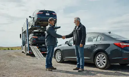 Vehicle owner beside their delivered car in Alaska, United States