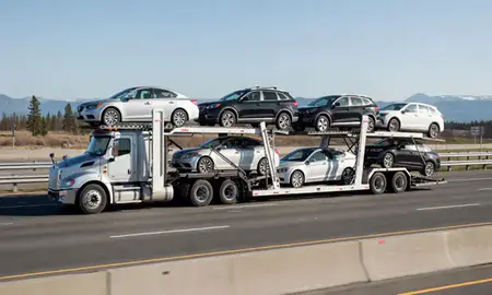 Multi-level car carrier on the highway to Anchorage, Alaska, United States