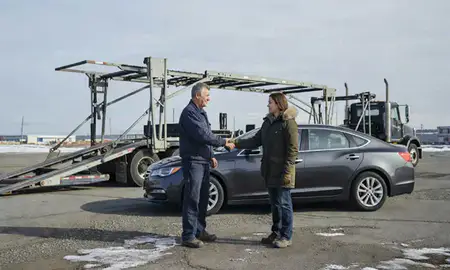 Vehicle owner beside their delivered car in Anchorage, Alaska, United States