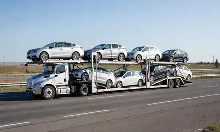Multi-level car carrier on the highway to Badger, Alaska, United States