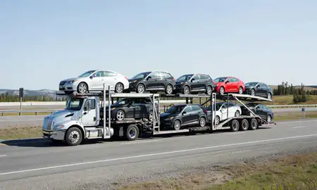 Multi-level car carrier on the highway to Chena Ridge, Alaska, United States