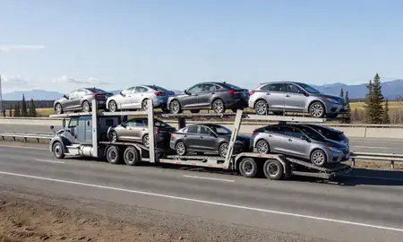 Multi-level car carrier on the highway to College, Alaska, United States
