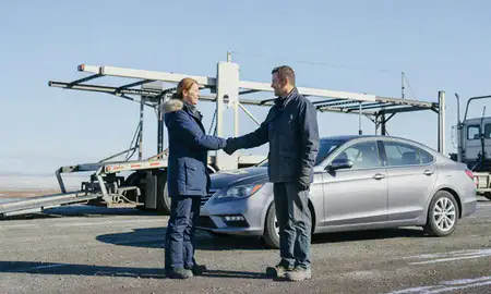 Vehicle owner beside their delivered car in College, Alaska, United States