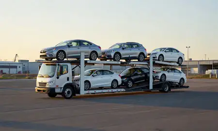 Car transporter loaded with vehicles in College, Alaska, United States