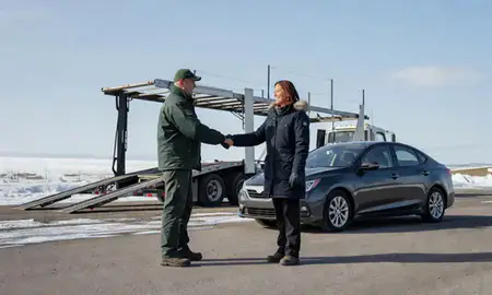 Vehicle owner beside their delivered car in Fairbanks, Alaska, United States
