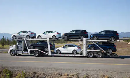 Multi-level car carrier on the highway to Farmers Loop, Alaska, United States