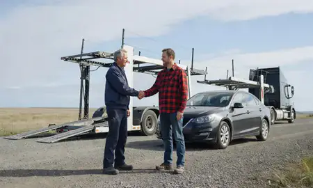 Vehicle owner beside their delivered car in Farmers Loop, Alaska, United States