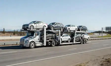 Multi-level car carrier on the highway to Gateway, Alaska, United States