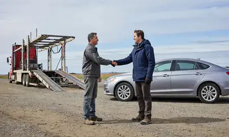 Vehicle owner beside their delivered car in Gateway, Alaska, United States