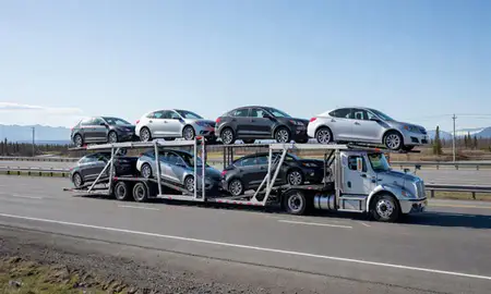 Multi-level car carrier on the highway to Homer, Alaska, United States