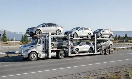 Multi-level car carrier on the highway to Juneau, Alaska, United States