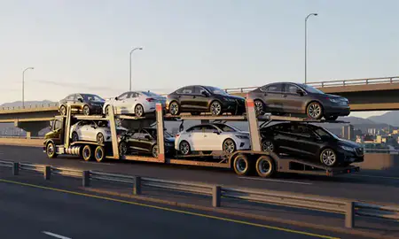 Car transporter with the Juneau, Alaska, United States skyline behind it