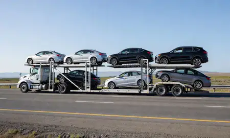 Multi-level car carrier on the highway to Kalifornsky, Alaska, United States