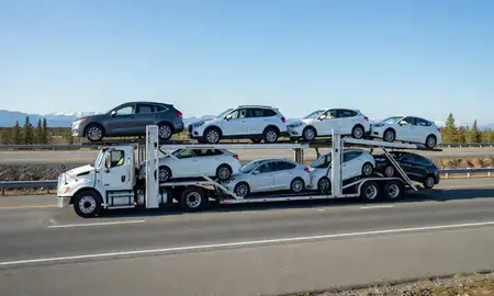 Multi-level car carrier on the highway to Kenai, Alaska, United States