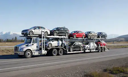 Multi-level car carrier on the highway to Kodiak, Alaska, United States